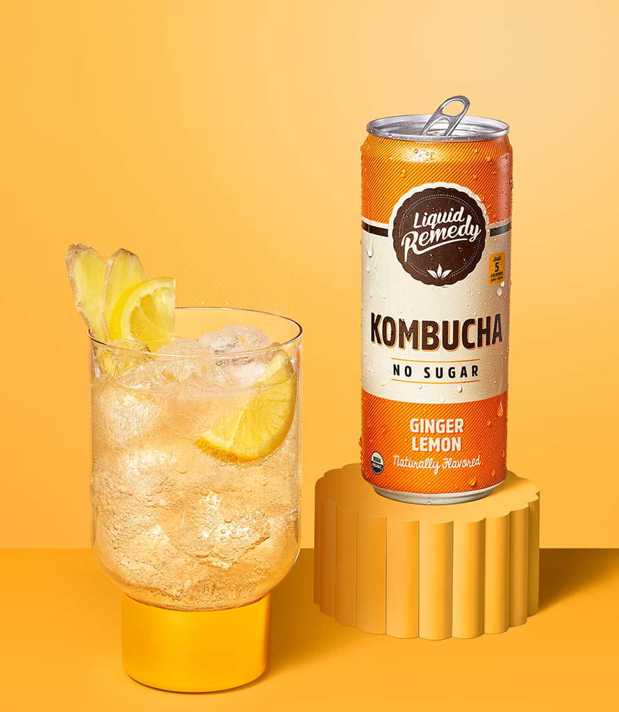 Liquid Remedy Ginger Lemon Kombucha Can with Glass Lifestyle