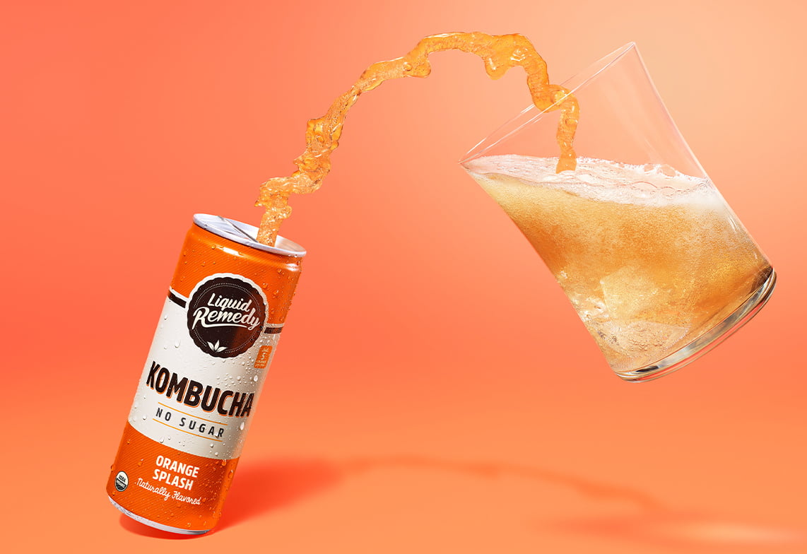 Liquid Remedy Orange Splash Kombucha Pouring into Glass
