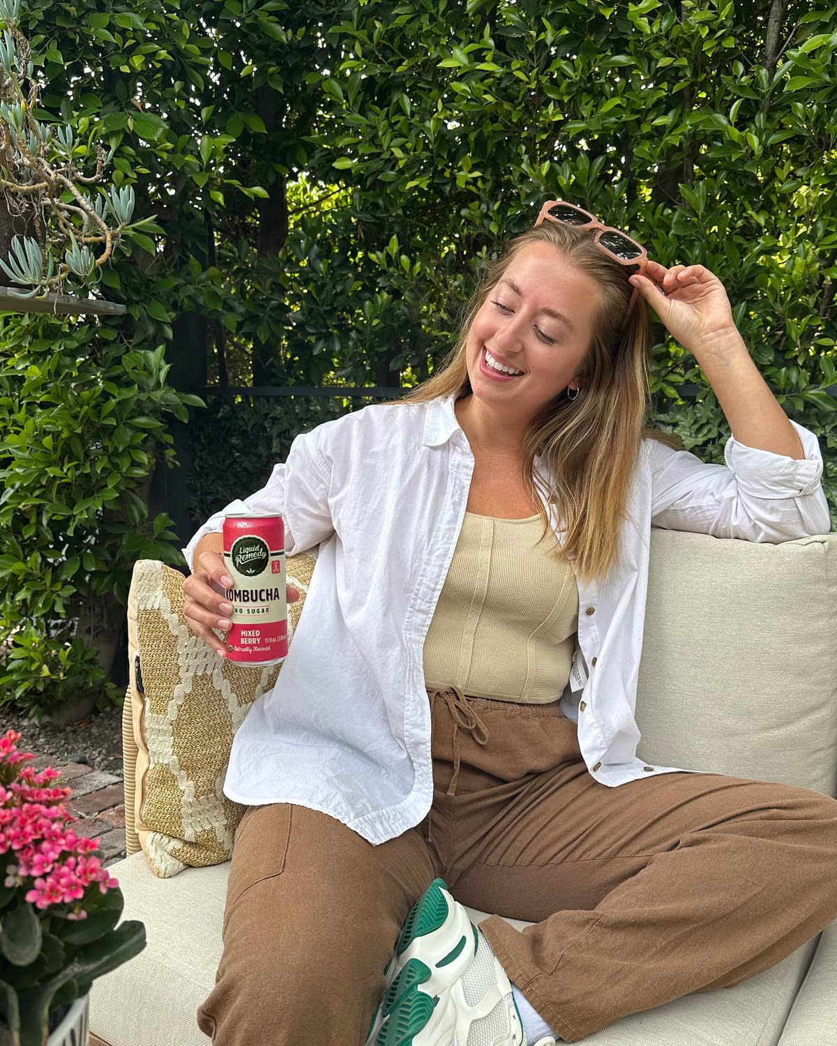 Girl holding a Liquid Remedy Mixed Berry Kombucha